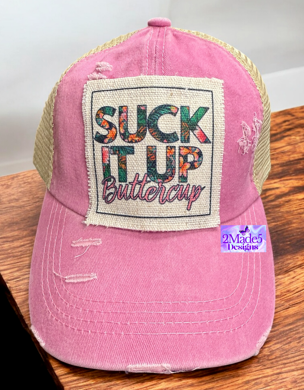 Suck It Up Buttercup Distressed Criss Cross Pink Ponytail Hat